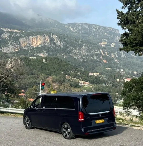 The van on a bend of the road, Corfu's mountains behind it