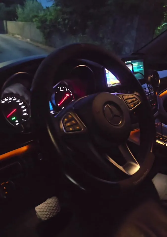 The taxi dashboard at dusk on a Corfu road